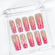 spotty nail art long square pink ombre press-on nails with black dots and bow details for summer