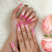 spotty nail art long square pink ombre press-on nails with black dots and bow details for summer