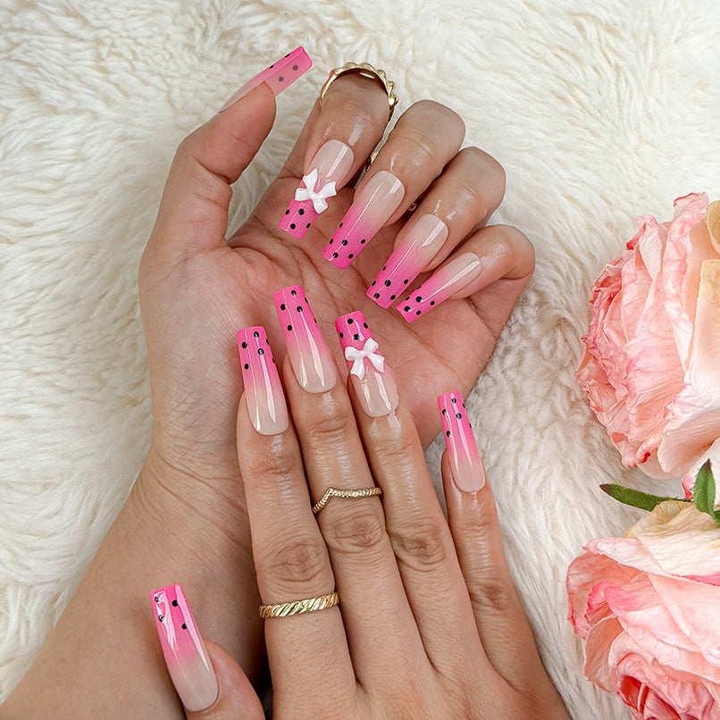 spotty nail art long square pink ombre press-on nails with black dots and bow details for summer