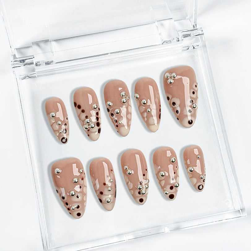 spotty nail art medium almond nude press-on nails with abstract dots and silver bead accents for spring prom