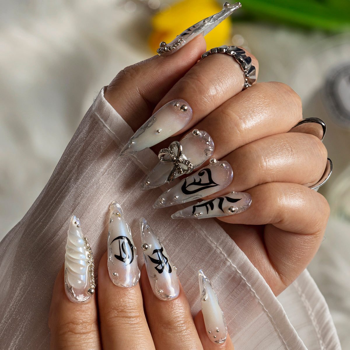 Silver Bow Noir STME0045 press-on nails hand model scene view 1