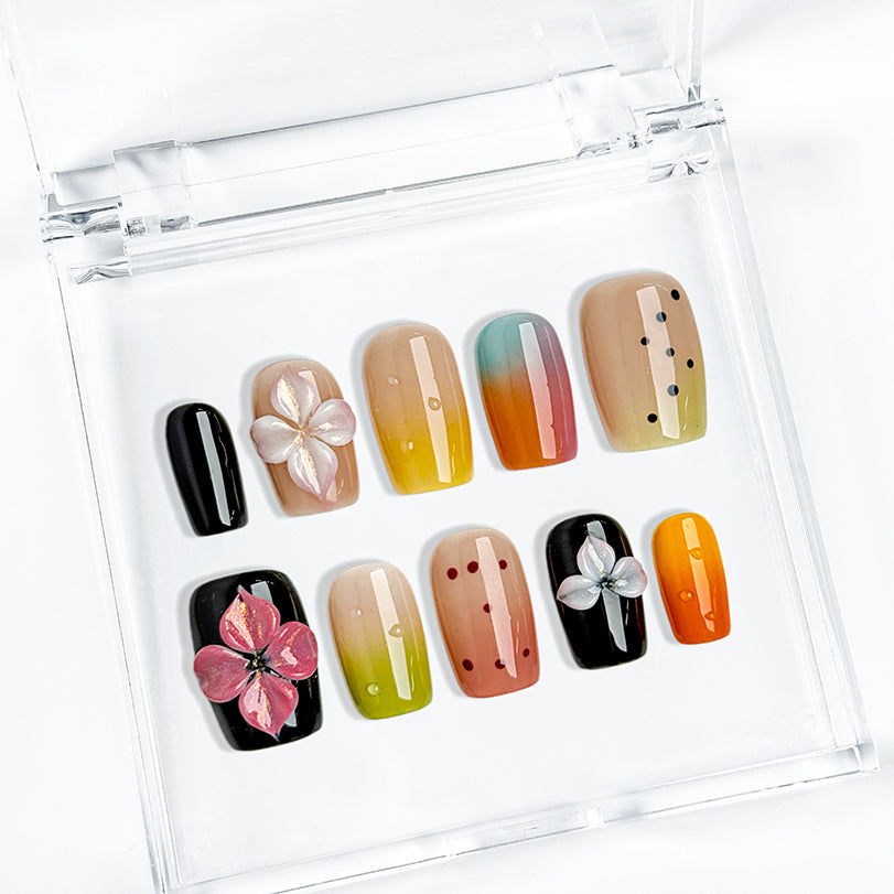 sunset pink and orange ombre nails short square press-on nails with black accents colorful ombre tips and flower details spring beach party style
