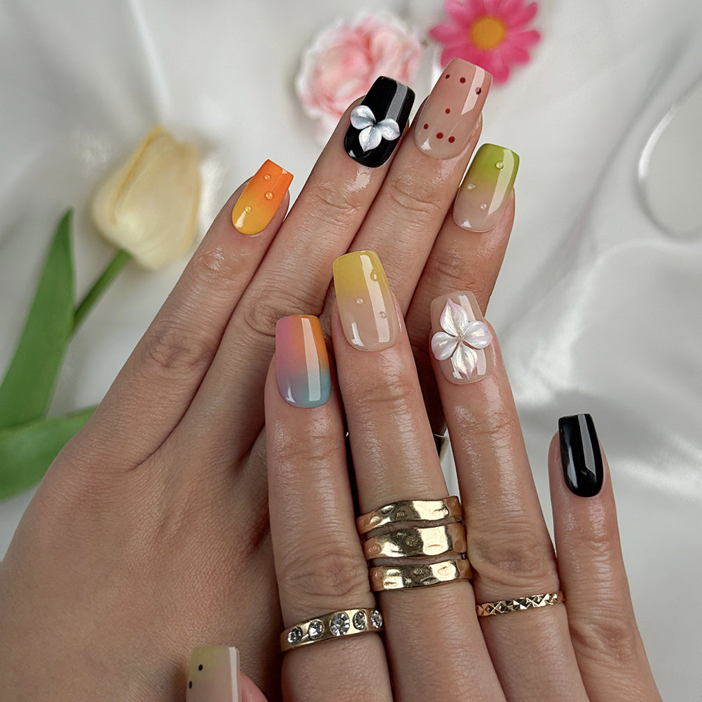 sunset pink and orange ombre nails short square press-on nails with black accents colorful ombre tips and flower details spring beach party style