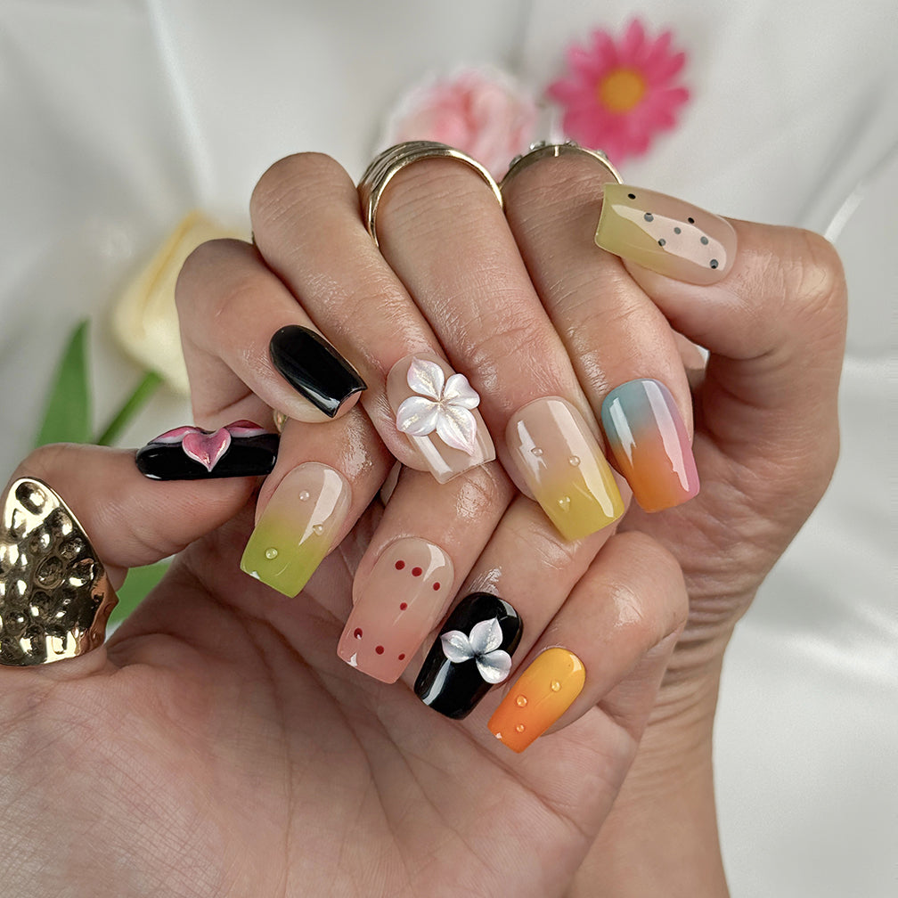 sunset pink and orange ombre nails short square press-on nails with black accents colorful ombre tips and flower details spring beach party style