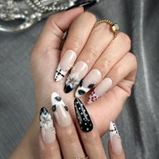 white and black polka dot nails medium almond press-on nails with nude base french tip details floral accents winter holiday cool style