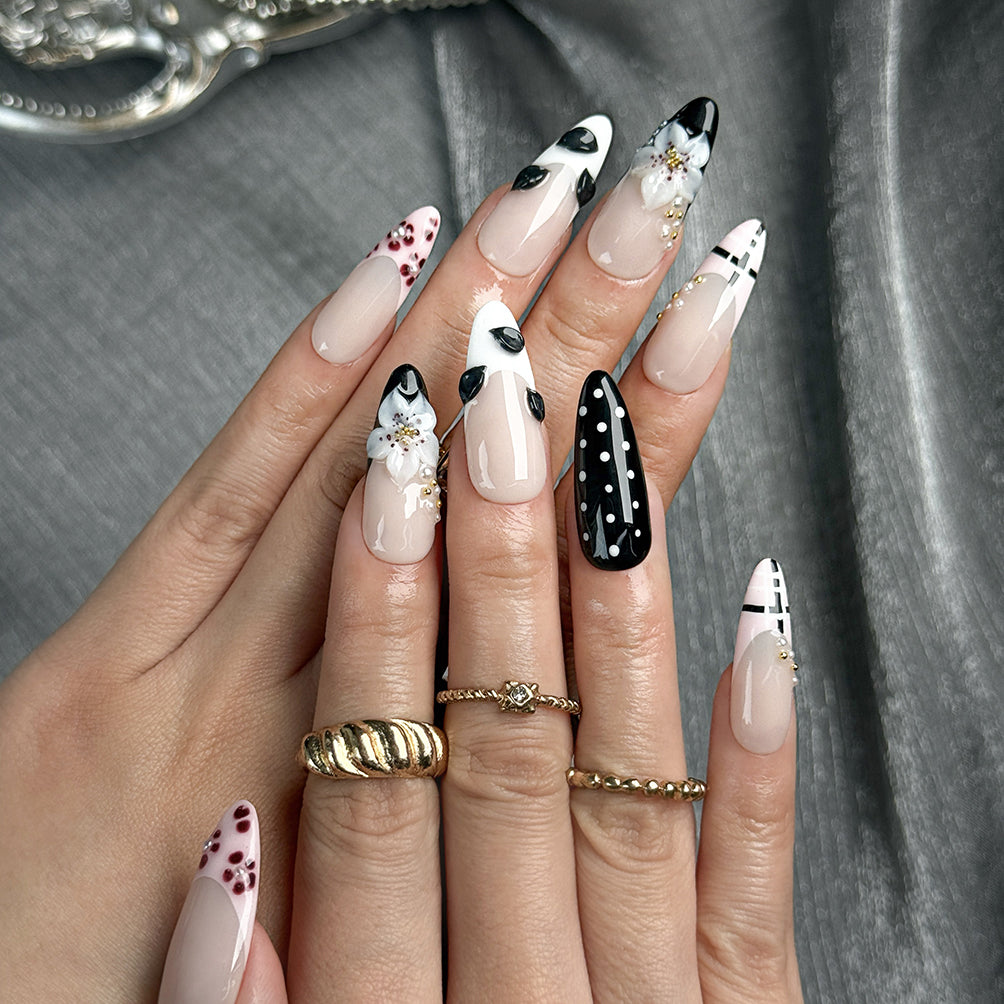 white and black polka dot nails medium almond press-on nails with nude base french tip details floral accents winter holiday cool style
