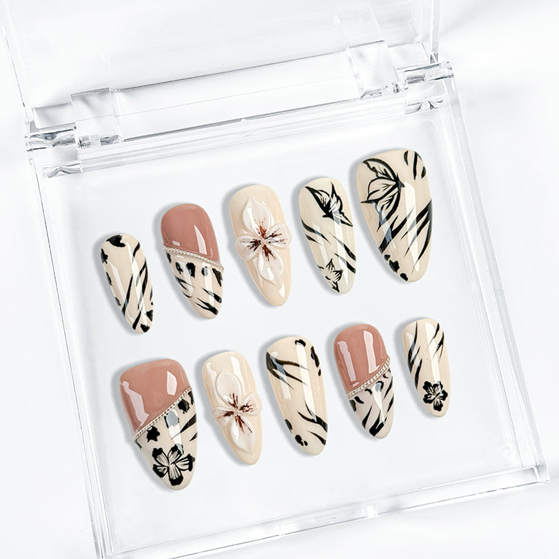 white black nail art medium almond press-on nails with floral design in white, black, and soft blush for summer holiday style