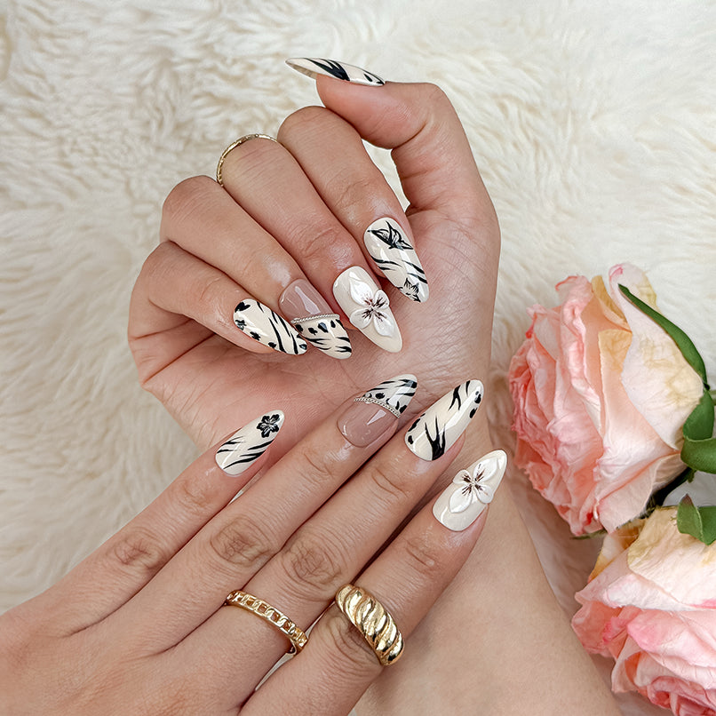 white black nail art medium almond press-on nails with floral design in white, black, and soft blush for summer holiday style