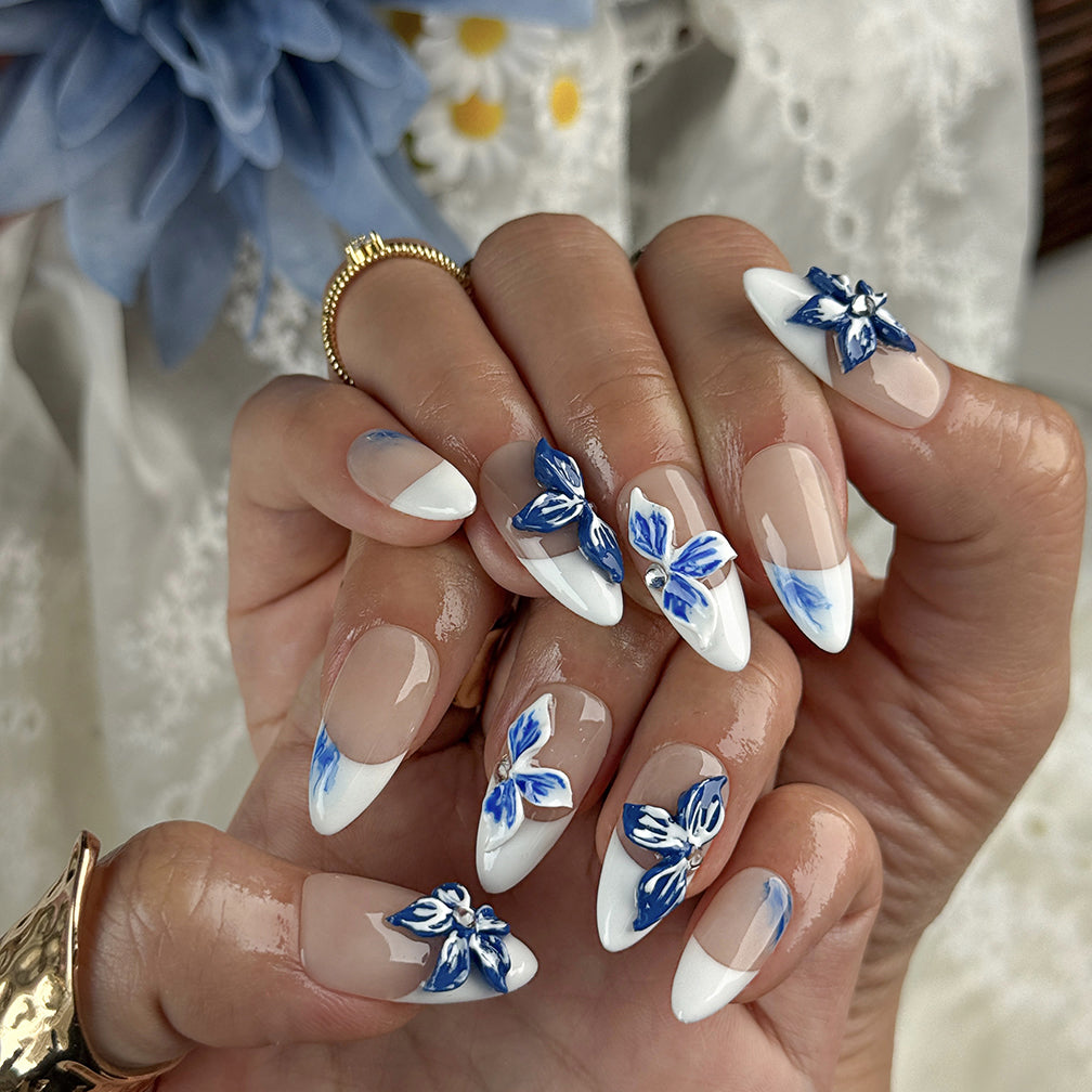 white flower nail designs medium almond press-on nails with blue floral accents and white french tips for summer beach party and prom style