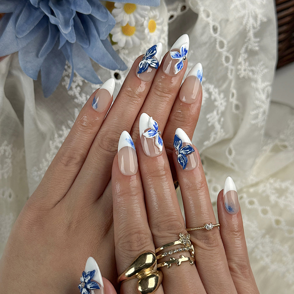 white flower nail designs medium almond press-on nails with blue floral accents and white french tips for summer beach party and prom style