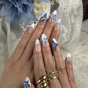 white flower nail designs medium almond press-on nails with blue floral accents and white french tips for summer beach party and prom style