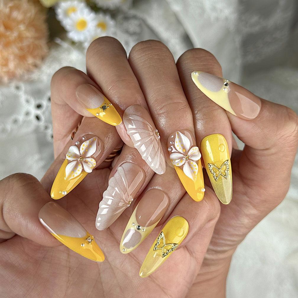 yellow flower nails long almond press-on nails with nude base orange and yellow french tips floral accents summer beach party style
