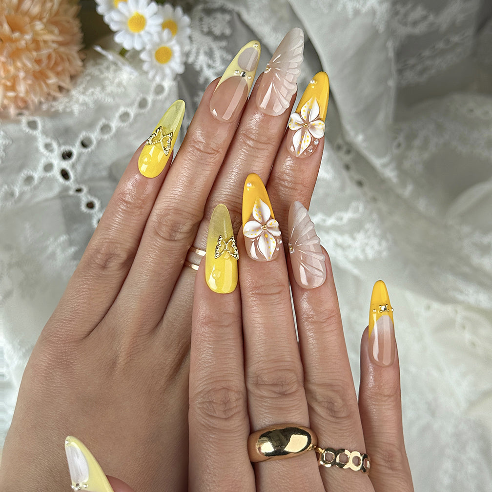 yellow flower nails long almond press-on nails with nude base orange and yellow french tips floral accents summer beach party style